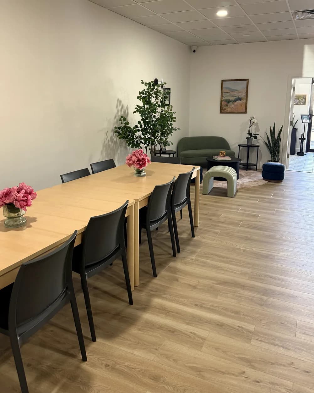 Bright, open Workshop room set with long tables and a lounge area